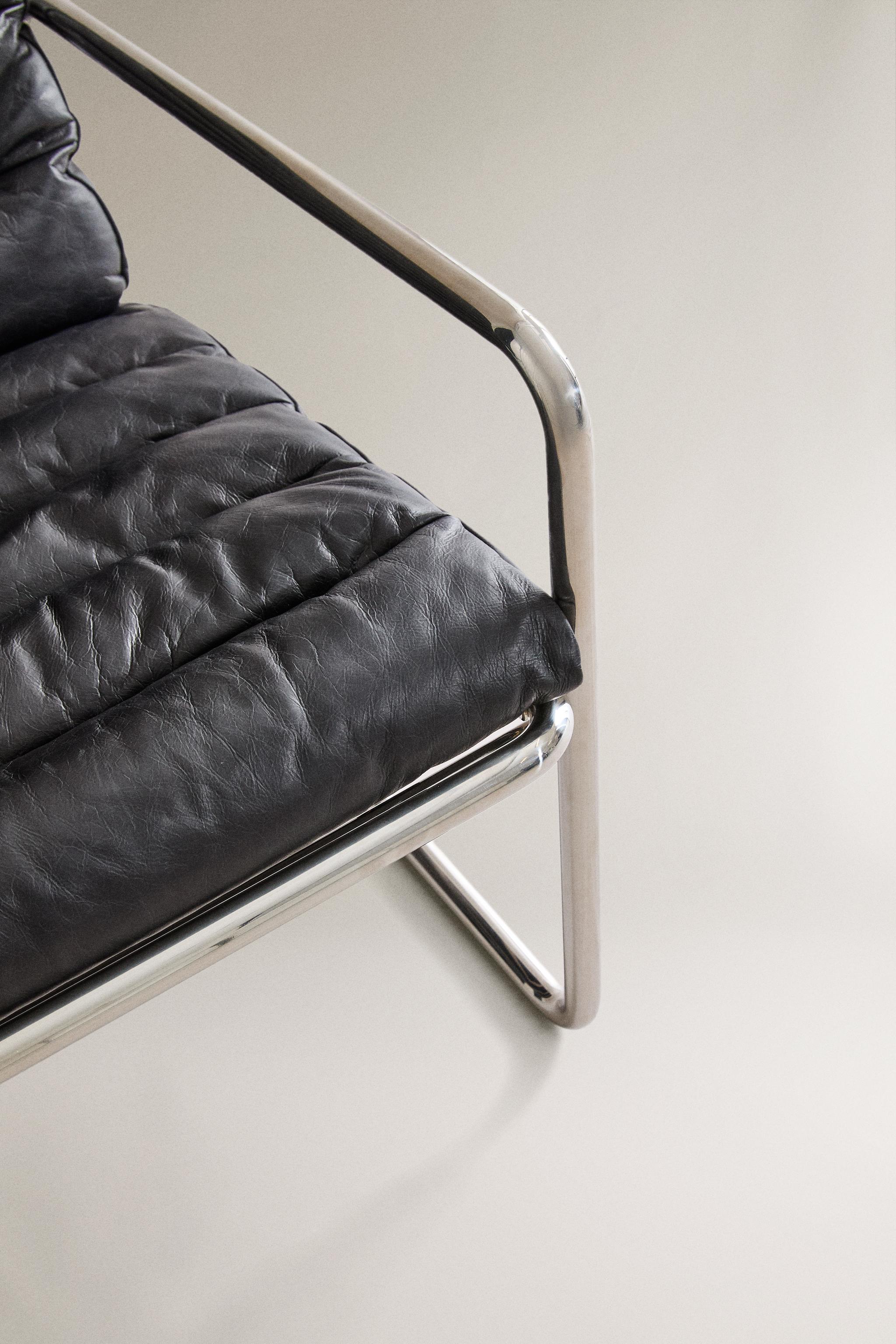 LEATHER AND STAINLESS STEEL ACCENT CHAIR